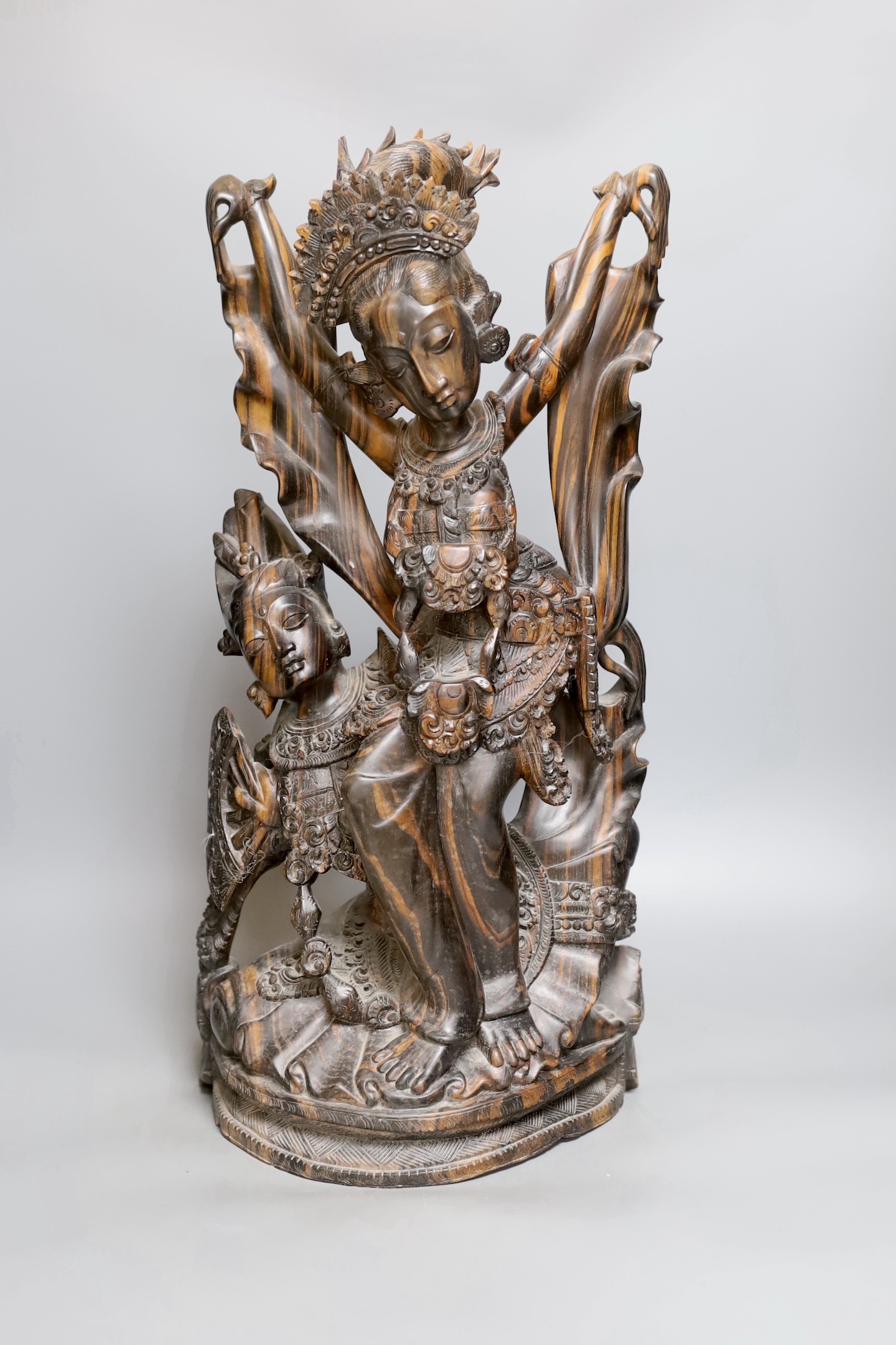 A Balinese carved coromandel deity group , 50 cms high.